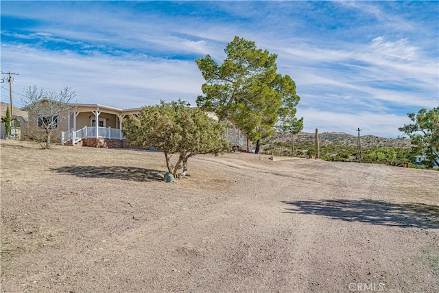 view of yard featuring covered porch