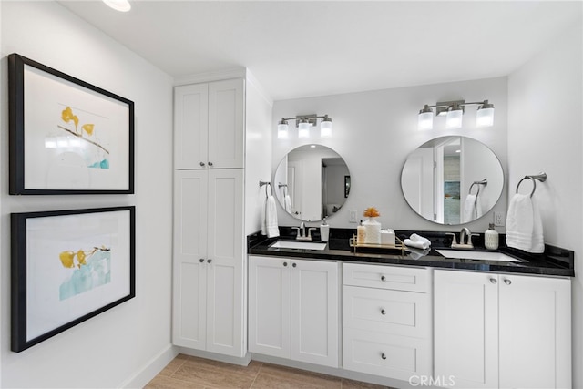 bathroom featuring double vanity and a sink