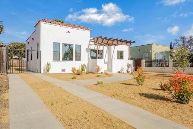 view of front of house featuring a gate, fence, a pergola, and stucco siding