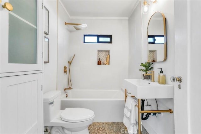 bathroom featuring toilet, a sink,  shower combination, and a healthy amount of sunlight