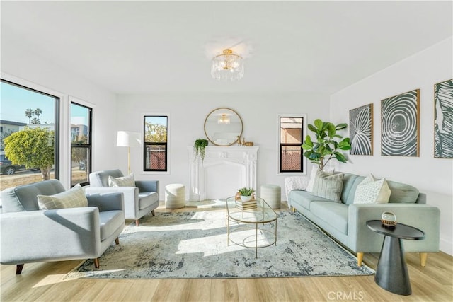 living area featuring wood finished floors and a chandelier