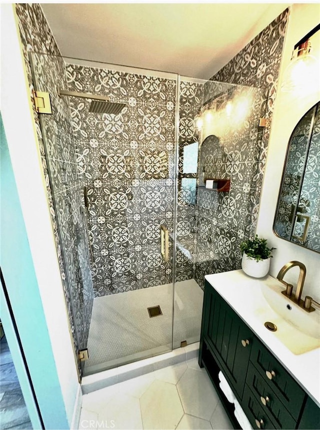 bathroom featuring vanity, tile patterned floors, and a shower stall