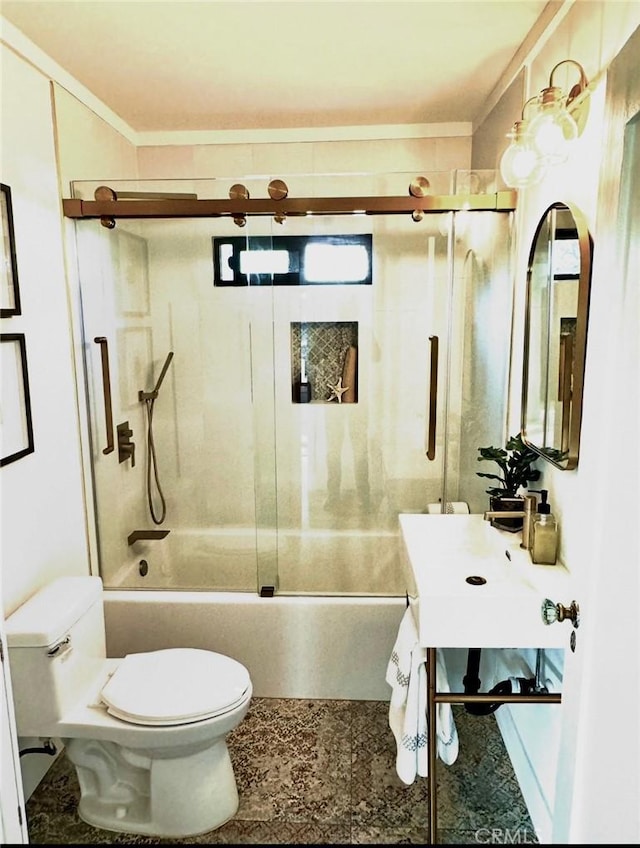 full bathroom featuring vanity, crown molding, toilet, and bath / shower combo with glass door