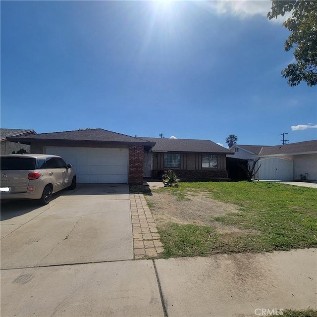 single story home featuring a front yard, concrete driveway, brick siding, and an attached garage