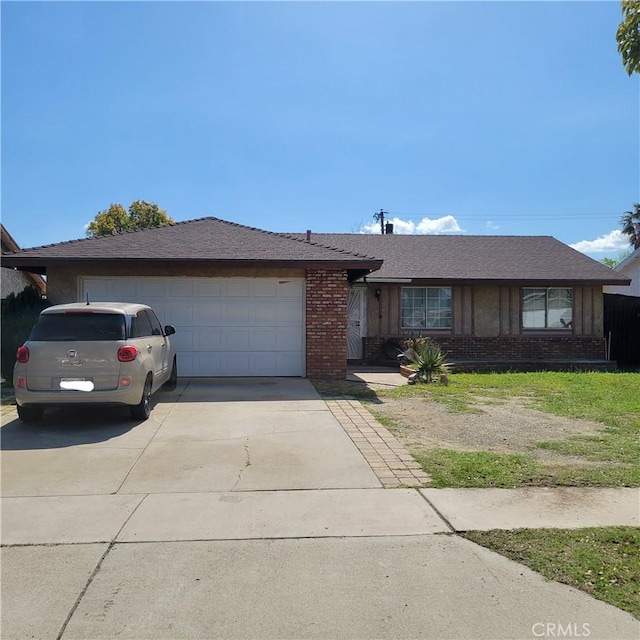 single story home with an attached garage, concrete driveway, and brick siding