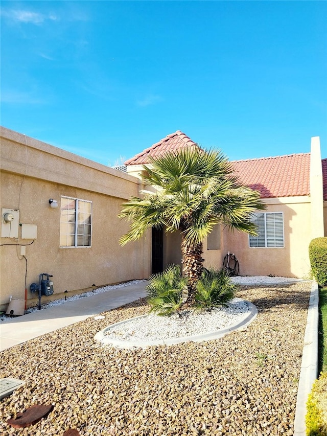 view of home's exterior featuring a tiled roof and stucco siding