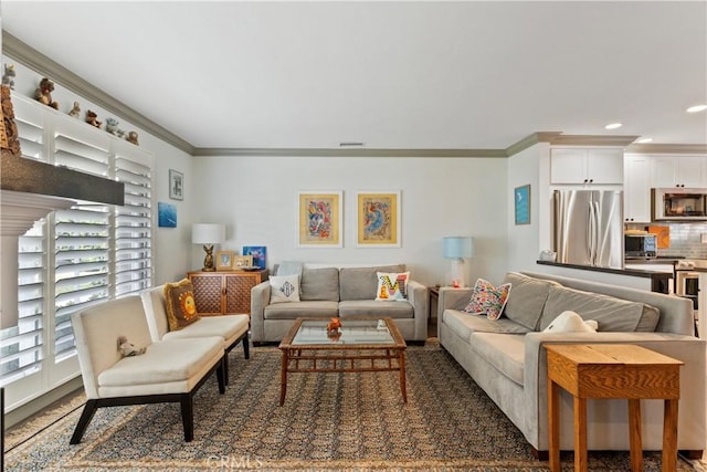 living room featuring visible vents, ornamental molding, and recessed lighting