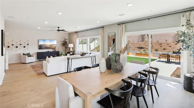 dining area with light wood finished floors, visible vents, and recessed lighting