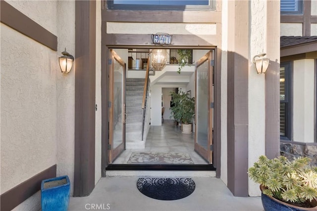 entrance to property featuring stucco siding