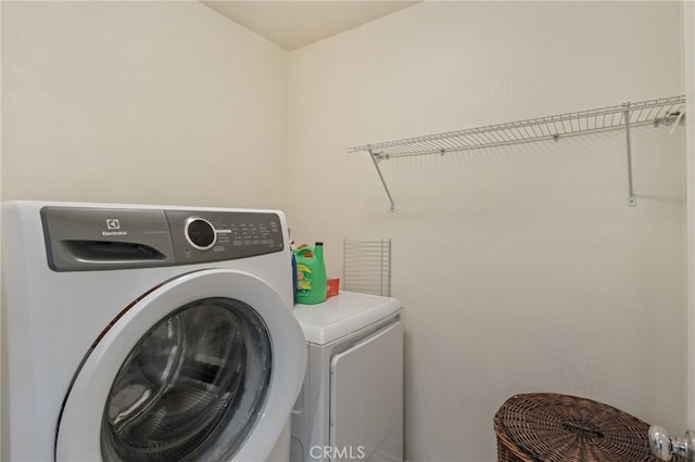 clothes washing area with laundry area and separate washer and dryer