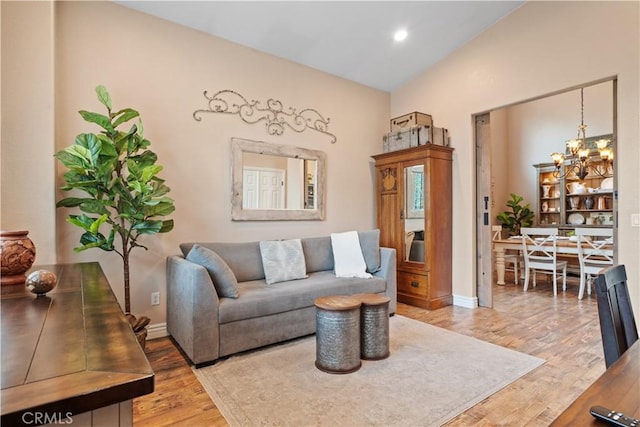 living room with baseboards, recessed lighting, wood finished floors, and an inviting chandelier