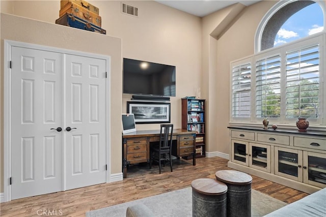 office area featuring wood finished floors, visible vents, and baseboards