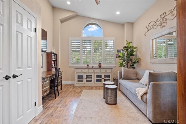 living area featuring recessed lighting, vaulted ceiling, baseboards, and wood finished floors