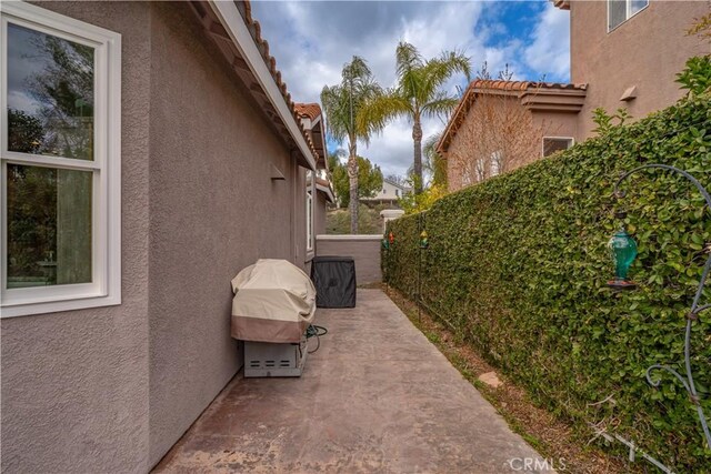 view of home's exterior featuring a patio, fence, and stucco siding