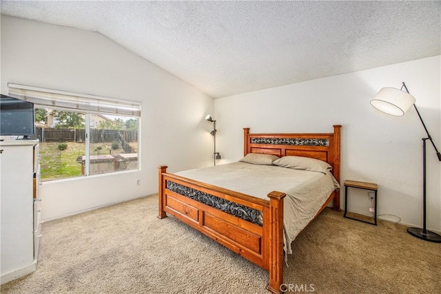 carpeted bedroom with vaulted ceiling and a textured ceiling