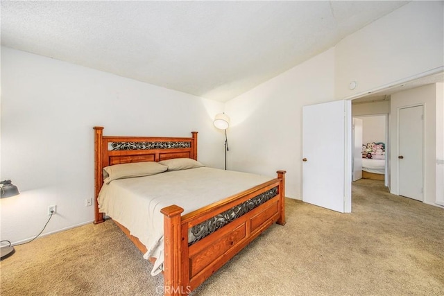 bedroom featuring lofted ceiling and light colored carpet