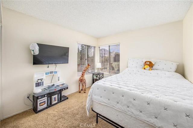 bedroom with a textured ceiling and carpet floors