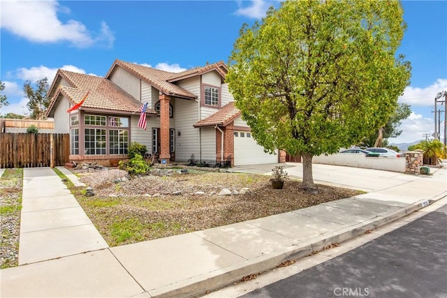 view of front of home with driveway, a garage, a tile roof, fence, and brick siding