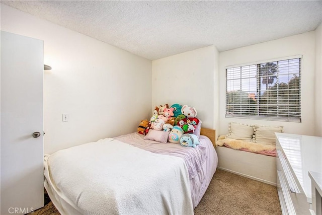 bedroom featuring a textured ceiling and carpet