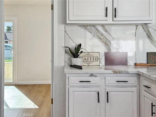 bar featuring baseboards and wood finished floors