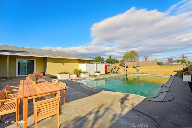 view of swimming pool with fence, a fenced in pool, and a patio