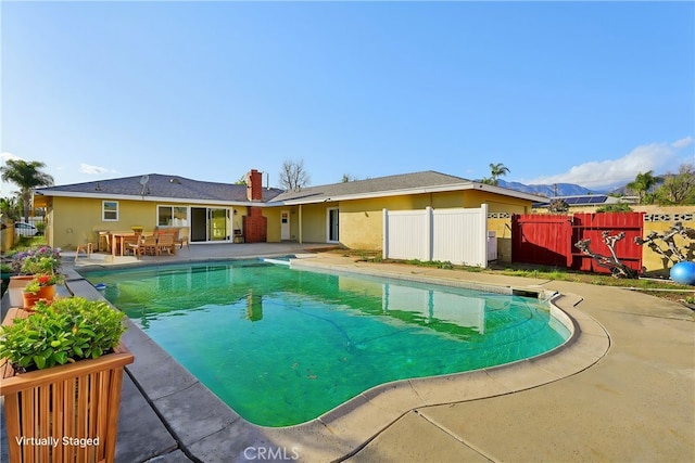 view of swimming pool featuring a fenced in pool, fence, and a patio