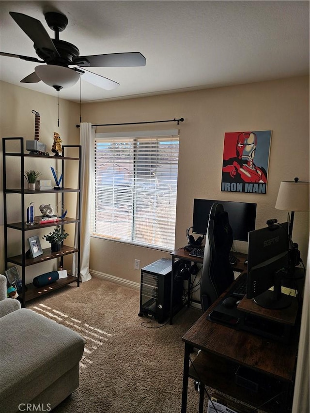 home office with a ceiling fan, carpet, and baseboards