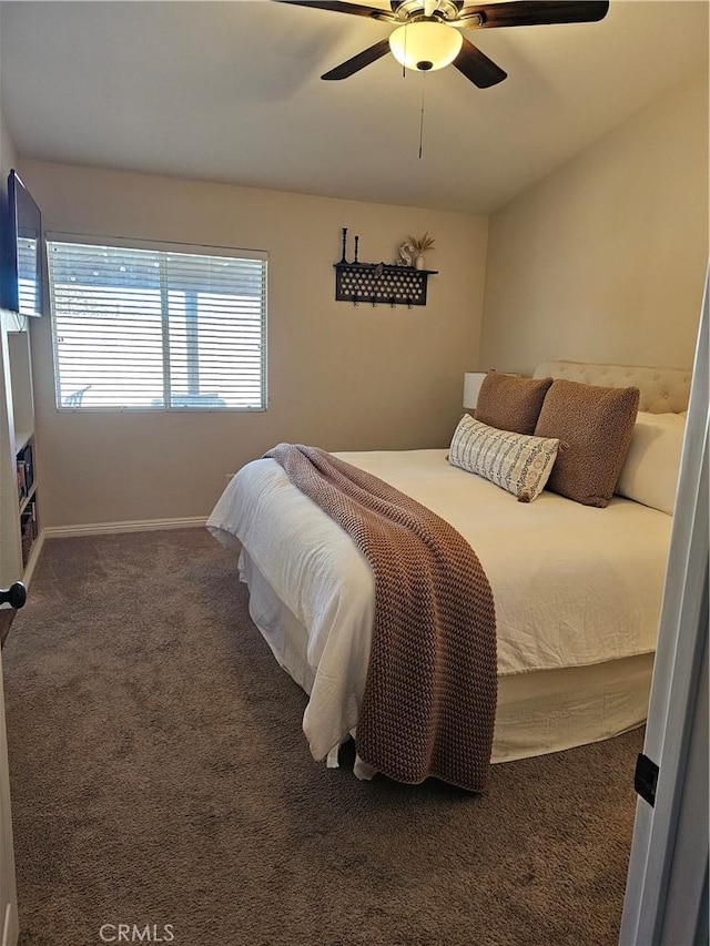 bedroom with ceiling fan, baseboards, and carpet flooring