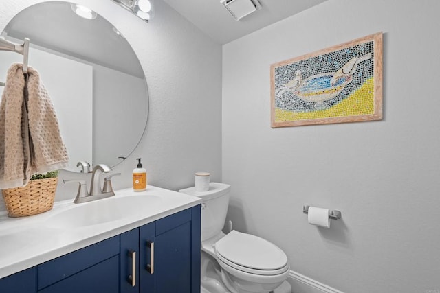 bathroom with visible vents, vanity, toilet, and baseboards