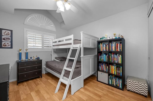 bedroom with vaulted ceiling, light wood-type flooring, and a ceiling fan