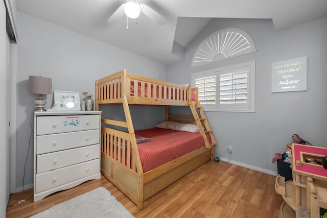 bedroom with ceiling fan, wood finished floors, and baseboards