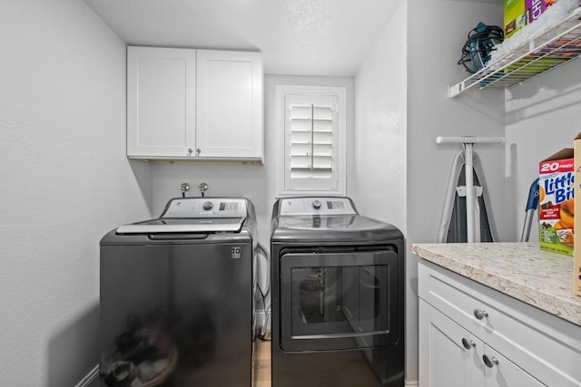 laundry room featuring cabinet space and washer and clothes dryer