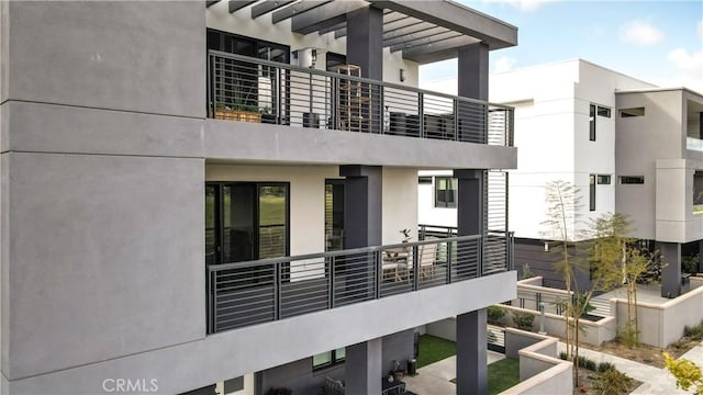 16289 Dawn Way Unit 204, Tustin, CA 92782 - rear view of house featuring a balcony and stucco siding