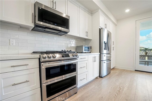 16289 Dawn Way Unit 204, Tustin, CA 92782 - kitchen with stainless steel appliances, light wood-style flooring, baseboards, recessed lighting, and white cabinetry