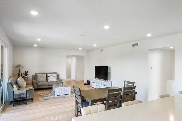 dining area featuring light wood-style floors, recessed lighting, and visible vents