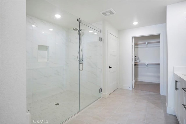 16289 Dawn Way Unit 204, Tustin, CA 92782 - full bath featuring a marble finish shower, vanity, a walk in closet, recessed lighting, and tile patterned floors