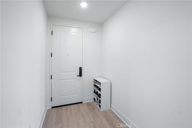 entryway featuring baseboards, recessed lighting, and light wood finished floors