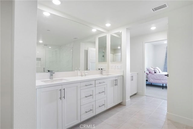 16289 Dawn Way Unit 204, Tustin, CA 92782 - ensuite bathroom featuring a marble finish shower, recessed lighting, double vanity, baseboards, and tile patterned flooring