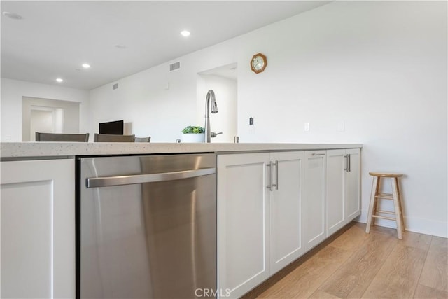 kitchen featuring visible vents, recessed lighting, white cabinetry, light wood-style flooring, and dishwasher