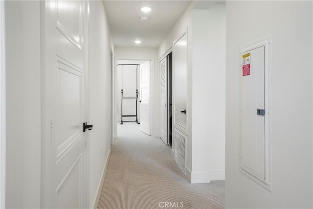 hall featuring recessed lighting, baseboards, and light colored carpet