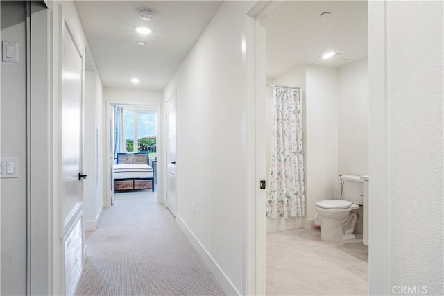 corridor with recessed lighting and baseboards