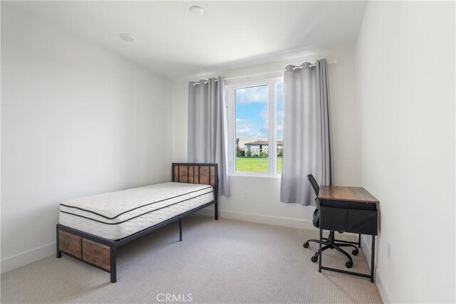 bedroom featuring carpet floors and baseboards