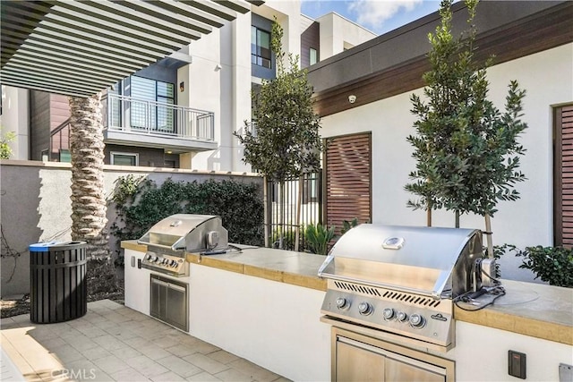 view of patio with grilling area and an outdoor kitchen