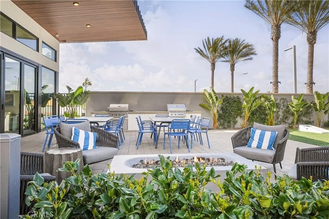 16289 Dawn Way Unit 204, Tustin, CA 92782 - view of patio / terrace featuring an outdoor living space with a fire pit, area for grilling, and outdoor dining area