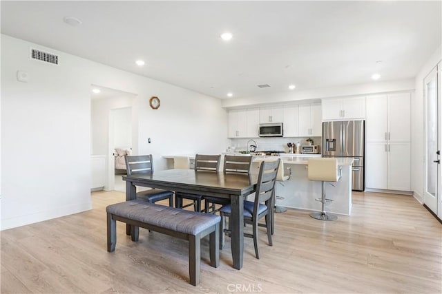 dining area featuring baseboards, recessed lighting, light wood-style flooring, and visible vents