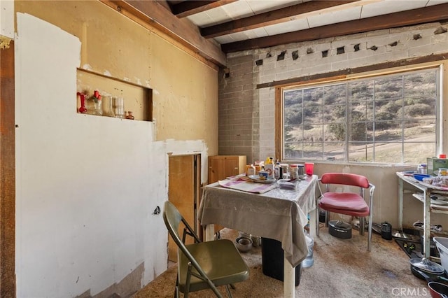 dining space with beam ceiling