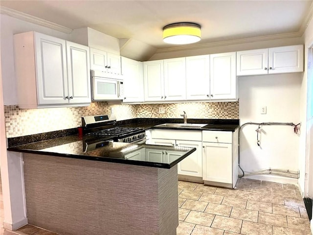 20146 Cohasset St Unit 15, Winnetka, CA 91306 - kitchen featuring white microwave, stainless steel gas range, a sink, a peninsula, and white cabinets