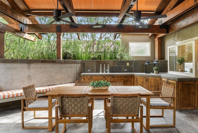 view of patio / terrace with outdoor wet bar, ceiling fan, and an outdoor kitchen