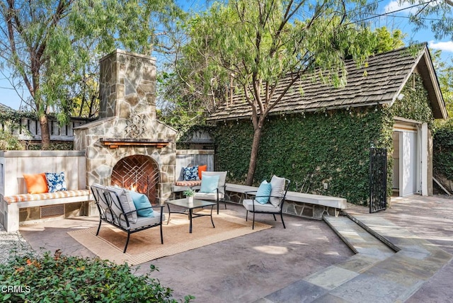 view of patio featuring an outdoor living space with a fireplace