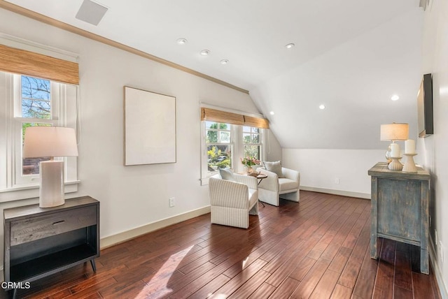 sitting room featuring baseboards, vaulted ceiling, and wood finished floors